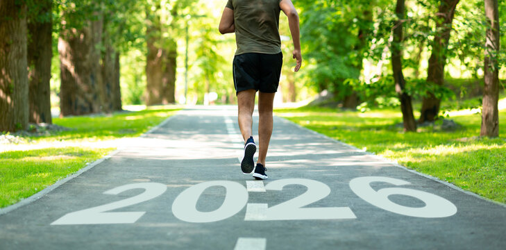 A person jogs along a tree-lined path marked by the year 2026. The scene captures a serene atmosphere, emphasizing the connection between fitness and nature during daytime.