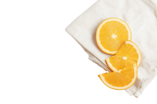Diagonal arrangement of fresh orange slices on a light textured cloth with transparent background