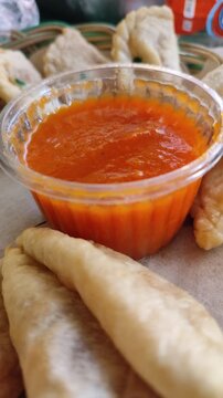Crispy cireng served warm with spicy savory sauce, showcasing its chewy texture and irresistible street-food appeal.