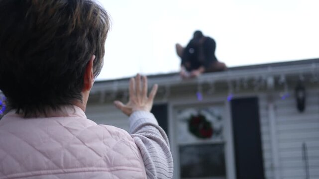 Homeowner directs man or contractor to arrange Christmas Lights