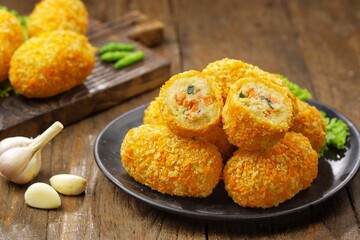 Kroket kentang. Croquettes are lumps of finely mashed potatoes filled with seasoned minced meat and...