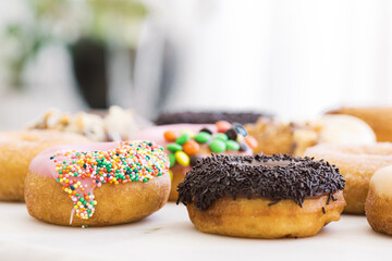 Horizontal shot of donuts with different toppings.