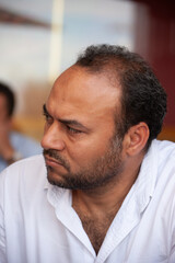 Obraz premium portrait of single Egyptian Arab man thinking, sited outdoors at a terrace