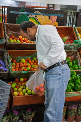 single Egyptian Arab man in the supermarket buying groceries on the isle with vegetables