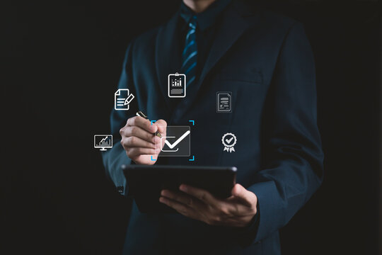 Businessman using digital tablet for online document management and quality assurance. Concept of business analytics, digital checklist, and data approval in modern technology workflow.