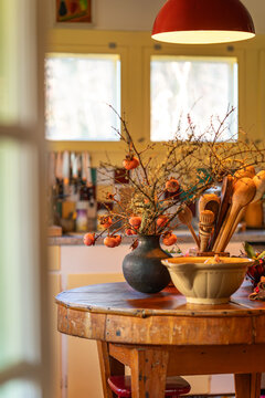 Seasonal Kitchen Scene with Persimmon Bouquet in Vase