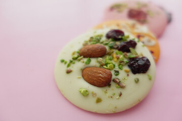 Colorful candy with nuts and fruits on pink