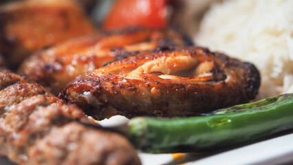 Grilled meat platter with rice and vegetables served fresh