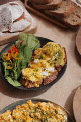 Delicious breakfast with eggs and fresh salad on a plate
