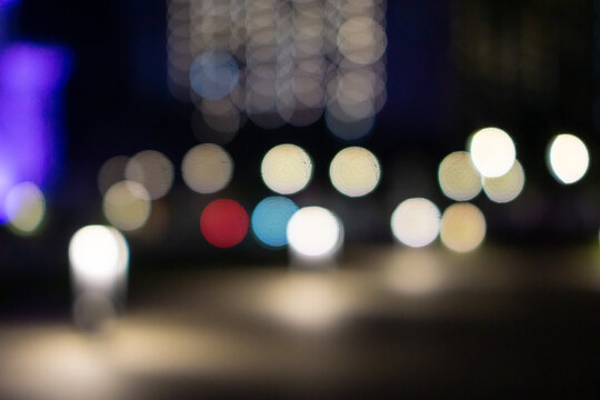 Abstract, blurred background of colorful city lights at night, creating circular bokeh effects. Ideal for overlay, background, wallpaper, or representing nightlife, atmosphere, and metropolitan life. - Powered by Adobe