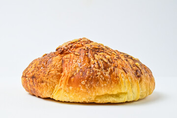 Side view of cheese croissant isolated on white background. Clipping path. Fresh, brown. close up.