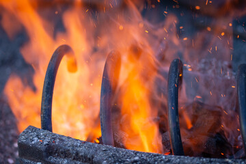 a wrought iron car arch, ,A blacksmith hardens steel at high temperature in a homemade furnace