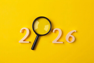 Creative 2026 New Year's Resolutions Concept With Magnifying Glass On Bright Yellow Background. 3d rendering.