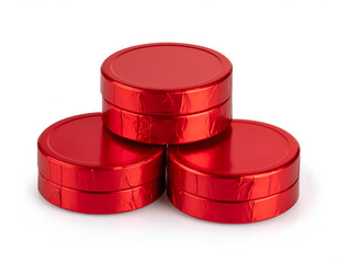 A trio of classic chocolate coins wrapped in vibrant red foil, stacked in a pyramid and isolated on a white background with reflective lighting