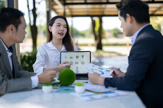 Business team discussing sustainable energy solutions meeting outdoors
