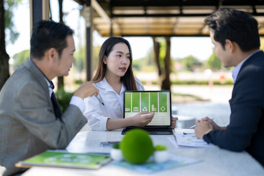 Business people discussing green energy financial investment with tablet