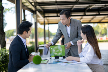 Business team discussing esg sustainability strategy on tablet