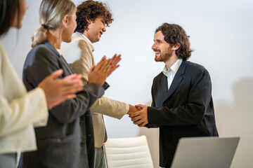 Multiracial team collaborating in modern office, diverse colleagues shaking hands during a business meeting, teamwork success, partnership agreement, professional collaboration multicultural workplace