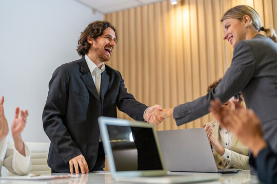 Multiracial team collaborating in modern office, diverse colleagues shaking hands during a business meeting, teamwork success, partnership agreement, professional collaboration multicultural workplace