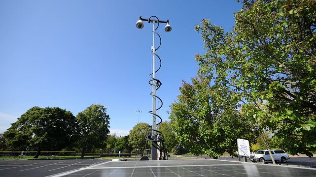 Mobile police surveillance tower with the multiple security cameras raised on a telescoping mast in a suburban neighborhood. public safety, monitoring