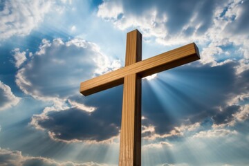 Wooden christian cross against dramatic sky with sunbeams