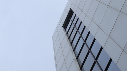 Rectangular glass windows line up neatly on a multi-story building.