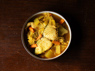 top view dish of GAENG SOM, Thai spicy sour curry with king mackerel fish