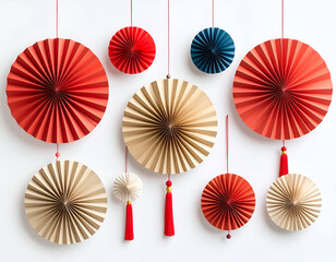 Vibrant flat lay arrangement of decorative pleated paper fans and rosettes, suspended for a festive holiday celebration backdrop against a clean white background