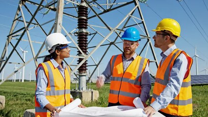Engineers Inspecting Power Infrastructure - A team of engineers in safety vests and hard hats are reviewing blueprints and discussing a power line. - Powered by Adobe