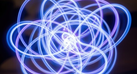 Abstract swirling blue and purple light trails creating a mesmerizing pattern