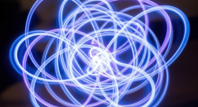 Abstract swirling blue and purple light trails creating a mesmerizing pattern