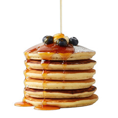 Stack of fluffy golden brown pancakes drizzled with sweet syrup topped with fresh blueberries and banana slices dusted with powdered sugar on a black background