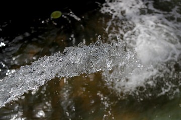 abstract blurred water splash texture on dark background for freshness concept