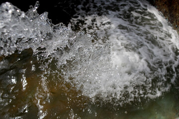 abstract blurred water splash texture on dark background for freshness concept