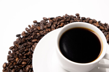 Cup with hot coffee and coffee beans below on a white background