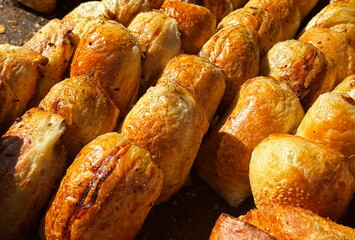 A variety of juicy samsa at a bazaar in Uzbekistan. Samsa from the Persian word samsa, is a savory dish from Central Asian cuisine