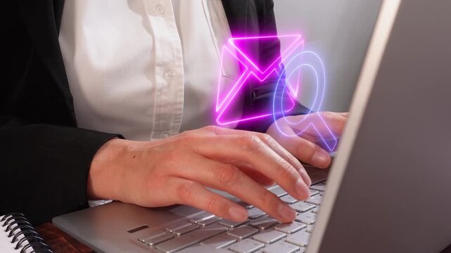 Searching and reviewing emails. Hands of a female executive focused while working on her laptop. With a virtual icon of a mail envelope with a magnifying glass.