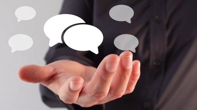 Concept of communication and dialogue. Close-up of a businesswoman's hand holding a speech bubble animation.