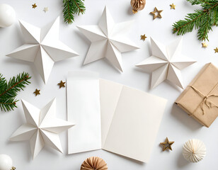 Flat lay of origami stars, paper ornaments, and instructions on a white surface