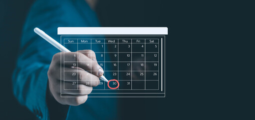 Businessman hand using digital pen marking date on virtual calendar interface, representing scheduling, appointment, planning, time management, and business organization concept modern technology.