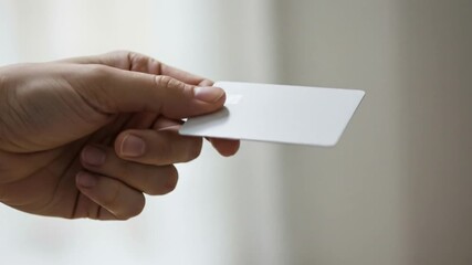 Close-up of a hand holding a credit card, symbolizing electronic payment, banking, shopping and financial transactions in modern commerce. - Powered by Adobe