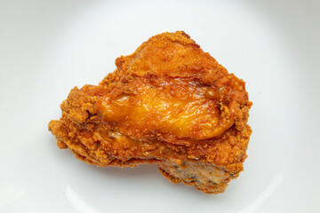 crispy fried chicken on white plate close up