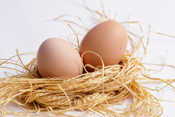 A bamboo basket with a wooden background is filled with delicious fried eggs.