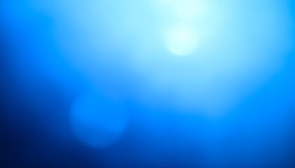 Abstract image featuring a gradient of blue hues with a bright, soft light source creating a dreamy, ethereal effect.