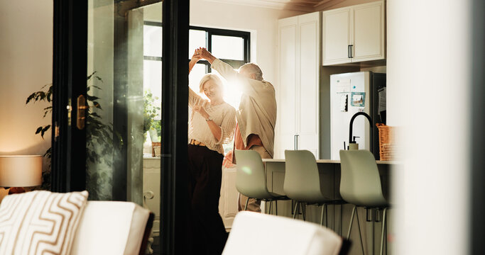 Elderly couple, love and dance in home for connection, marriage anniversary and spin. Romantic music, senior man and woman holding hands in kitchen for retirement, healthy relationship and smile - Powered by Adobe
