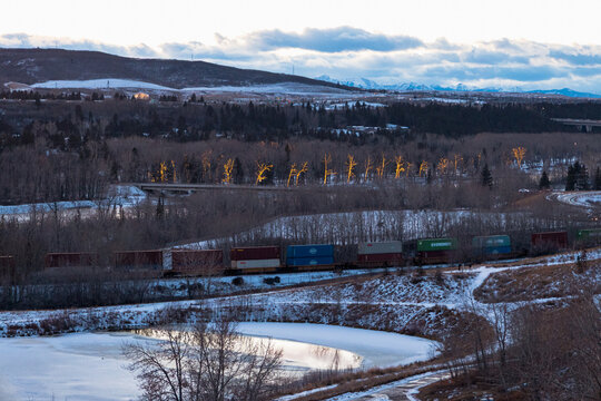 The CP freight train running through Bowmont Park in Calgary on a chilly winter evening. Calgary, AB, Canada - Dec-20-2023