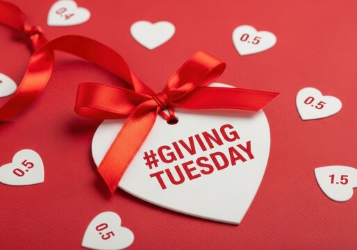 White heart tag with Giving Tuesday hashtag and red ribbon on red background image
