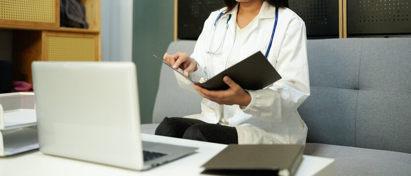 female woman doctor therapist working in office reading data