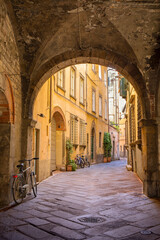 Narrow, cobblestone alley in Lucca, Italy
