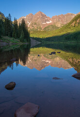 Maroon Bells, crystal clear Maroon Lake and beautiful summer reflections in early morning near Aspen, Colorado
